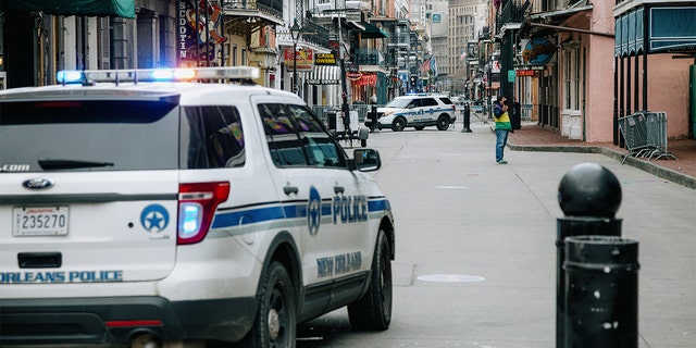 Police vehicles block access to Bourbon Street in New Orleans, Louisiana, Tuesday, Feb. 16, 2021. On Thursday, city leaders voted to reinstate facial recognition technology for police to use as crime continues to increase. 