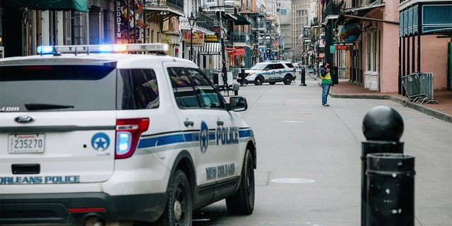 Police vehicles block access to Bourbon Street in New Orleans, Louisiana, Tuesday, Feb. 16, 2021. On Thursday, city leaders voted to reinstate facial recognition technology for police to use as crime continues to increase. 