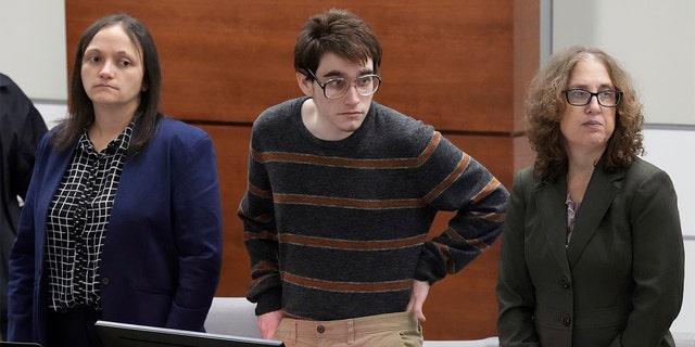 Marjory Stoneman Douglas High School shooter Nikolas Cruz tucks his sweater in while waiting for prospective jurors to enter the courtroom during jury pre-selection in the penalty phase of his trial at the Broward County Courthouse in Fort Lauderdale, Fla., on Tuesday, April 26, 2022. 