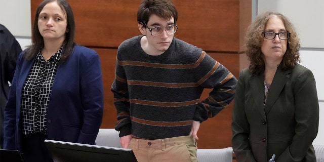 Marjory Stoneman Douglas High School shooter Nikolas Cruz tucks his sweater in while waiting for prospective jurors to enter the courtroom during jury selection in the penalty trial at the Broward County Courthouse in Fort Lauderdale, Florida, April 26, 2022. 