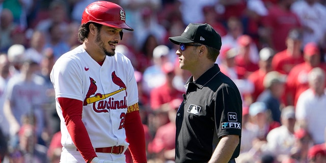 St.  Louis Cardinals' Nolan Arenado, left, quarrels with referee crew chief Mark Wegner after being ousted during the eighth round of a baseball game against the New York Mets on Wednesday, April 27, 2022 in St. Louis.  Louis. 