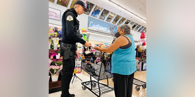 Oceanside Police Department officers gave $  100 to grocery shoppers this month for the department’s Random Acts of Kindness Project.