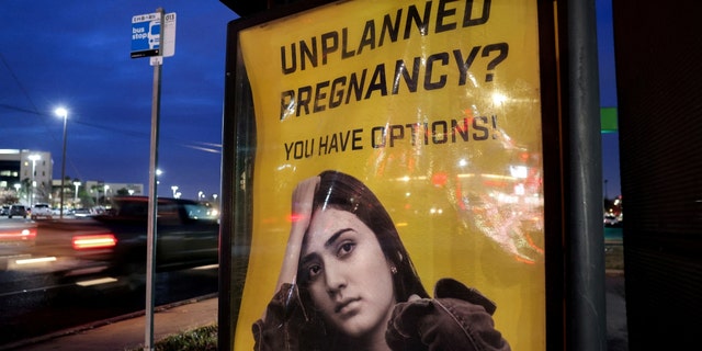 A billboard advertising adoption service targets pregnant women at a bus stop in Oklahoma City, Oklahoma, U.S., December 7, 2021. 
