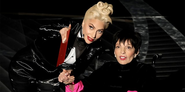 Lady Gaga and Liza Minnelli speak onstage during the 94th Annual Academy Awards at Dolby Theater on March 27, 2022, in Hollywood, California.  Said one etiquette adviser about the way Gaga handled the interaction, "She chose to give Minelli all the glory while preserving her dignity."