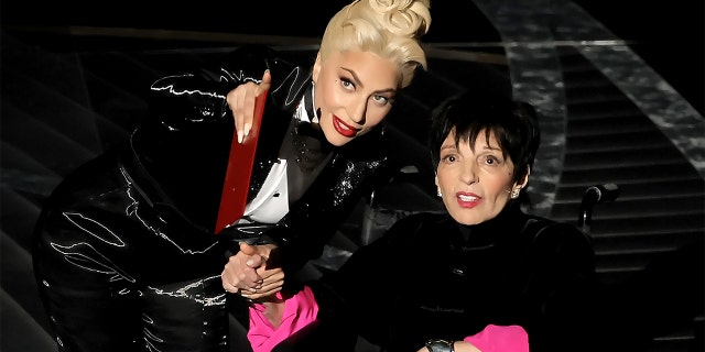 Lady Gaga and Liza Minnelli speak onstage during the 94th Annual Academy Awards at Dolby Theater on March 27, 2022, in Hollywood, California. Said one etiquette adviser about the way Gaga handled the interaction, "She chose to give Minelli all the glory while preserving her dignity."