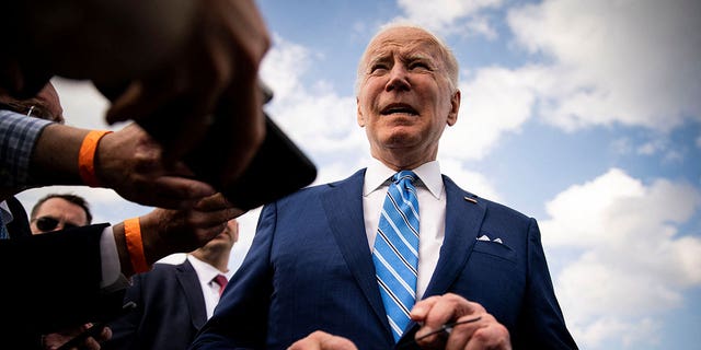 U.S. President Biden speaks to reporters while departing at Des Moines International Airport in Des Moines, Iowa, U.S., April 12, 2022. 