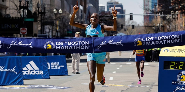 Peres Jepchirchir, of Kenya, crosses the finish line to win the women's division of the 126th Boston Marathon, Monday, April 18, 2022, in Boston.