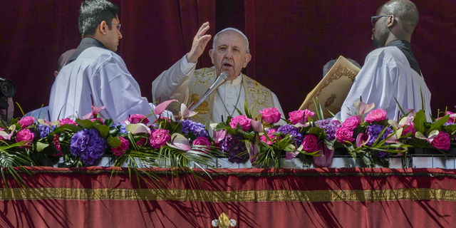Pope Francis delivers the traditional 'Urbi et Orbi' (To the city and to the world) blessing at the end of the Catholic Easter Sunday mass he led in St. Peter's Square at the Vatican on Sunday.