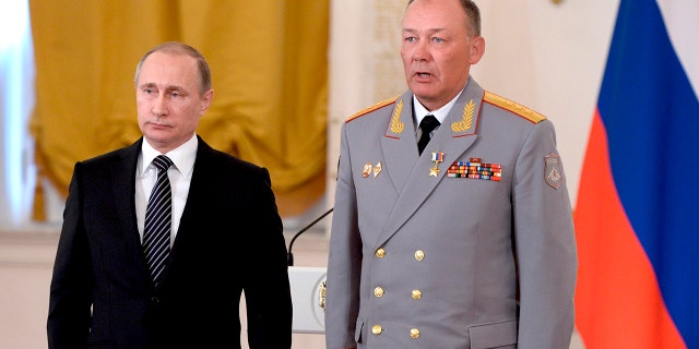 In this photo taken on March 17, 2016, Russian President Vladimir Putin, left, poses with Col. Gen. Alexander Dvornikov during an awarding ceremony in Moscow's Kremlin, Russia. Russia has appointed a new Ukraine war commander. A top U.S. official on Sunday, April 10, 2022 said Russia named Gen. Dvornikov as commander of an armed campaign that Russian authorities still refer to as a "special military operation."