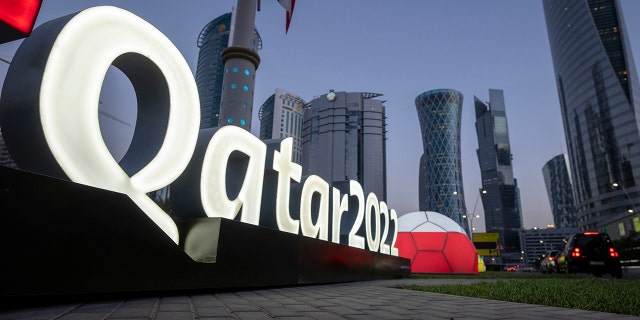 Branding is displayed near the Doha Exhibition and Convention Center where soccer's World Cup draw will be held, in Doha, Qatar, Thursday, March 31, 2022. The final draw will be held on April 1.