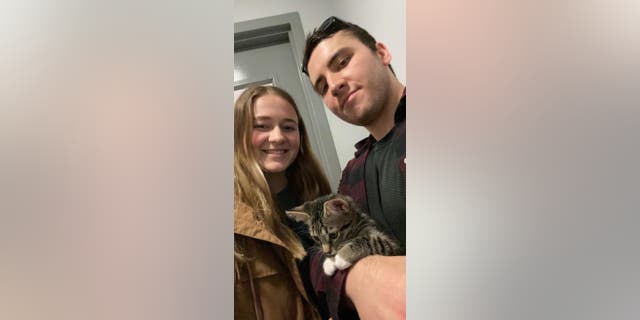 Grayson Martin (left) and Justin Blake (right) are co-owners of their eight-month-old cat Trevor, who has a habit of climbing into open fridges.