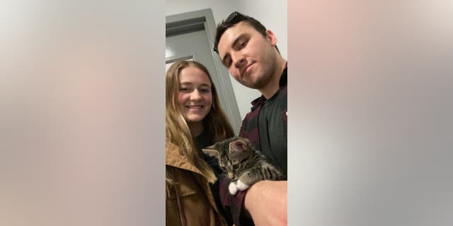 Grayson Martin (left) and Justin Blake (right) co-own their eight-month-old cat Trevor, who has a habit of climbing into open fridges.