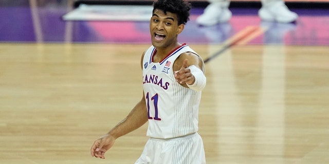 Kansas guard Remy Martin (11) celebrates his three-point shot against North Carolina during the first half of a college basketball game in the finals of the Men's Final Four NCAA tournament, Monday, April 4, 2022, in New Orleans.