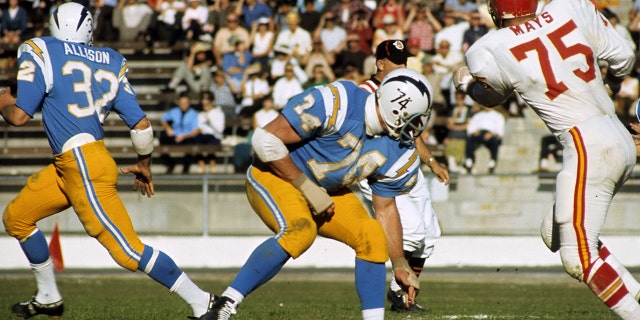 Offensive tackle Ron Mix (74) of the San Diego Chargers blocks Chiefs defensive lineman Jerry Mays (75) in a 27 to 17 loss to the Kansas City Chiefs on December 18, 1966 at San Diego Stadium in San Diego, California.
