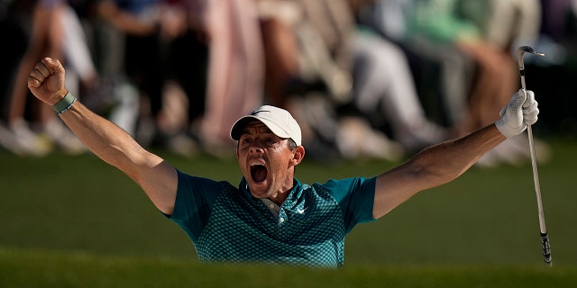 Rory McIlroy, of Northern Ireland, reacts after holing out from the bunker for a birdie during the final round at the Masters golf tournament on Sunday, April 10, 2022, in Augusta, Ga.