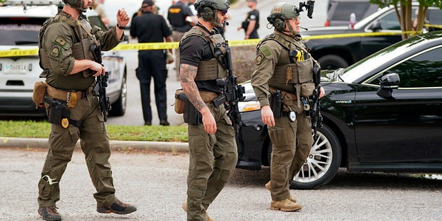 Authorities stage outside Columbiana Centre mall in Columbia, S.C., following a shooting, Saturday, April 16, 2022. (AP Photo/Sean Rayford)