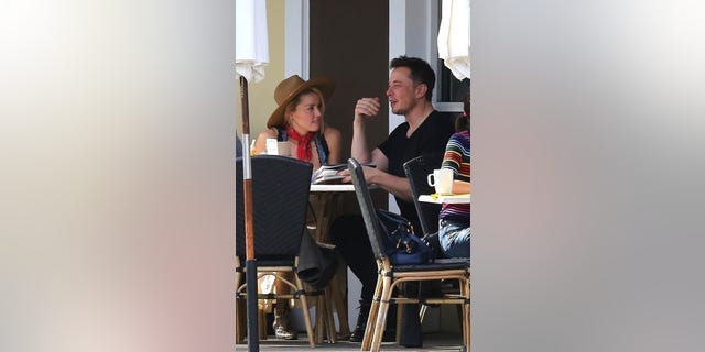 Elon Musk and Amber Heard pictured enjoying a meal.  Elon Musk was to testify via WebEx video link but will no longer, his lawyer confirmed to Fox News Digital. 