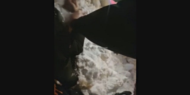 Purdue Officer Jon Selke pins Adonis Tuggle to a snow bank in newly released body camera footage.