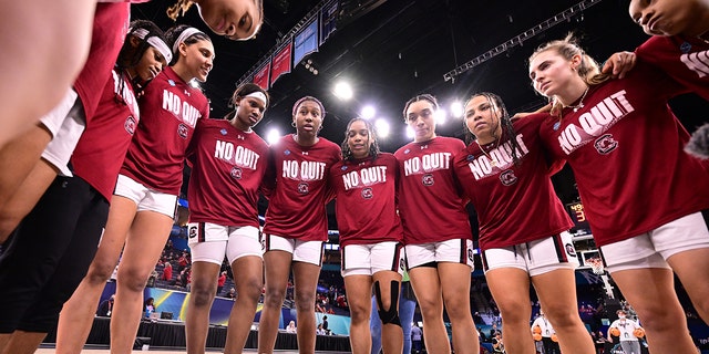 South Carolina Gamecocks players huddle before their game against the Louisville Cardinals during the semifinals of the NCAA Womens Basketball Tournament at the Target Center on April 1, 2022 in Minneapolis, Minnesota.