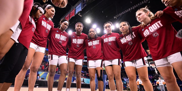 South Carolina Gamecocks players huddle before their game against the Louisville Cardinals during the semifinals of the NCAA Womens Basketball Tournament at the Target Center on April 1, 2022 in Minneapolis, Minnesota.