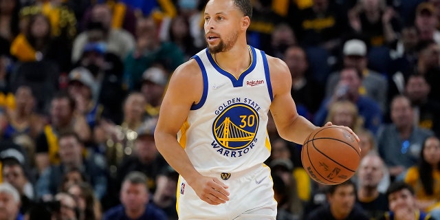 Golden State Warriors guard Stephen Curry dribbles the ball up the court against the Denver Nuggets during the second half of Game 2 of an NBA basketball first-round playoff series in San Francisco, Monday, April 18, 2022.