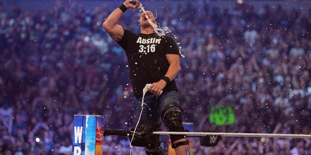 Stone Cold Steve Austin celebrates with beer during WrestleMania at AT&T Stadium in Arlington, Texas, on Apr 3, 2022.