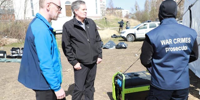 Sen. Steve Daines speaks with investigators in the Ukrainian city of Bucha.