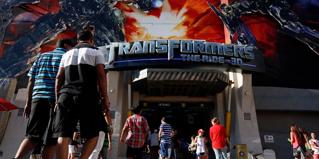 Visitors enter "Transformers: The Ride-3D" at the Universal Studios Hollywood theme park in Hollywood, California, U.S., on Thursday, Aug. 15, 2013.