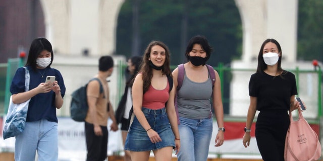 People wear face masks to protect against the spread of the coronavirus in Taipei, Taiwan, Wednesday, April 27, 2022. 