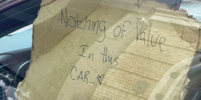 Sign inside vehicle parked in San Francisco's Tenderloin district.