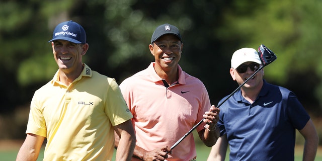 Tiger Woods of the United States will walk from the practice field with TGR Executive Vice President Rob McNamara and Billy Horsekel of the United States before the Masters at the Augusta National Golf Club on April 3, 2022 in Augusta, Georgia.