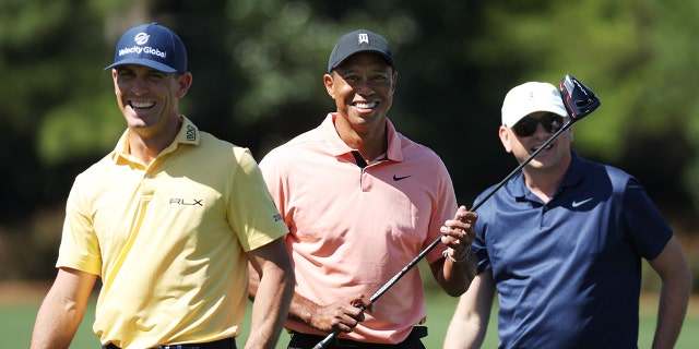 Tiger Woods of the United States walks from the practice area with Rob McNamara, Executive Vice President at TGR, and Billy Horschel of the United States prior to the Masters at Augusta National Golf Club on April 3, 2022 in Augusta, Georgia.