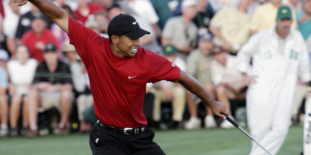 Tiger Woods celebrates after making the winning putt on the 18th green on April 10, 2005, during the final round of the 2005 Masters Tournament.