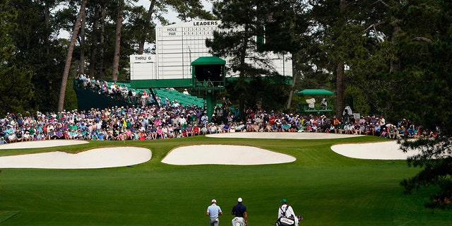 Justin Thomas, left, and Tiger Woods walk to the event green during a practice round for the Masters golf tournament on Monday, April 4, 2022, in Augusta, Georgia.