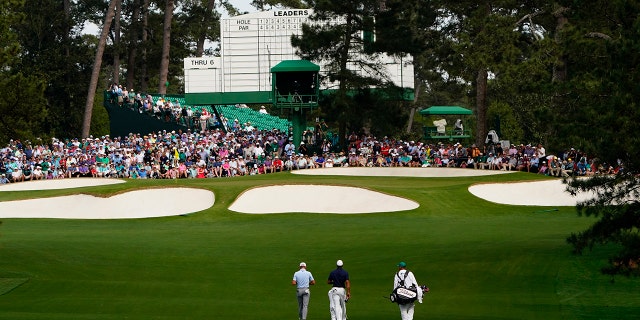 Justin Thomas, left, and Tiger Woods walk to the event green during a practice round for the Masters golf tournament on Monday, April 4, 2022, in Augusta, Georgia.