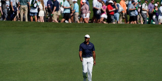 Tiger Woods walks down the fourth fairway during a practice round for the Masters golf tournament on Monday, April 4, 2022, in Augusta, Ga.