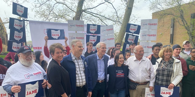 Sen. Rob Portman R-Ohio, and Ohio GOP Senate candidate Jane Timken pose with volunteers at Timken's campaign headquarters on April 30, 2022. (Tyler Olson/Fox News)
