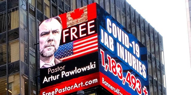 A sign calls for the freedom of Pastor Artur Pawlowski in Times Square in New York City, New York.
