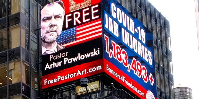 A sign in Times Square calls for the freedom of Pastor Artur Pawlowski in March 2022 while he was being imprisoned in Alberta after speaking to the trucker convoy.