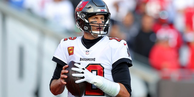 Tom Brady #12 of the Tampa Bay Buccaneers looks to pass against the Los Angeles Rams during the first half in the NFC Divisional Playoff game at Raymond James Stadium on January 23, 2022 in Tampa, Florida.