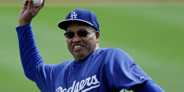 FILE - Former Los Angeles Dodgers great Tommy Davis throws out a ceremonial pitch before an exhibition spring training baseball game against the Seattle Mariners, Saturday, March 9, 2013, in Glendale, Ariz. Davis, a two-time National League batting champion who won three World Series titles with the Los Angeles Dodgers, died Sunday night, April 3, 2022, in Phoenix, the Dodgers announced Monday. He was 83. (AP Photo/Mark Duncan, File)