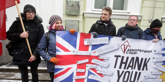 Ukrainians hold a banner as they take part at a rally to thank Great Britain for supplying Ukraine with weapons, outside the British Embassy in Kyiv, Ukraine on Jan. 21.