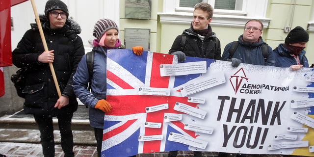 Ukrainians hold a banner as they take part at a rally to thank Great Britain for supplying Ukraine with weapons, outside the British Embassy in Kyiv, Ukraine on Jan. 21.