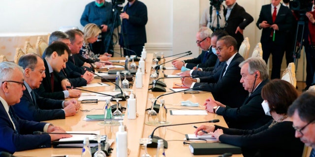 Russian Foreign Minister Sergei Lavrov, second from left, and UN Secretary-General Antonio Guterres, center right, talk during their meeting in Moscow, Russia, Tuesday, April 26, 2022. 