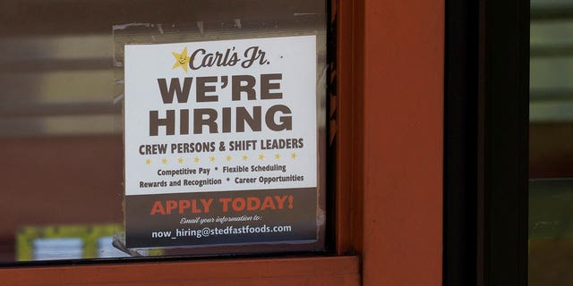 FILE PHOTO: A help wanted sign is shown at a fast food restaurant in Solana Beach, California, U.S. November, 9, 2021. REUTERS/Mike Blake/File Photo