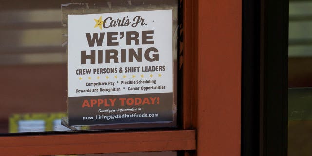 FILE PHOTO: A help wanted sign is shown at a fast food restaurant in Solana Beach, California, U.S. November, 9, 2021. REUTERS/Mike Blake/File Photo