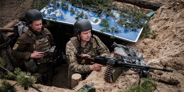 TOPSHOT - Ukrainian soldiers rest at their position near Lyman, eastern Ukraine, on April 28, 2022, amid Russian invasion of Ukraine. 