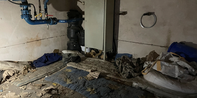 Dirty mattresses are seen on a cement floor of a factory room where Russian troops held Red Cross volunteers Volodymyr Khropun and Yulia Ivannikova-Katsemon together with dozens of other locals in the village of Dymer, Ukraine.