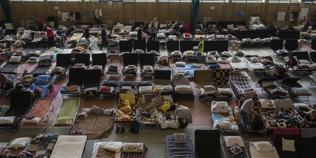 People who fled the war in Ukraine rest inside an indoor sports stadium being used as a refugee center, in the village of Medyka, a border crossing between Poland and Ukraine, on March 15.