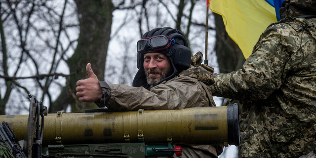 Ukrainian soldiers are riding on armored fighting vehicles in eastern Ukraine. 